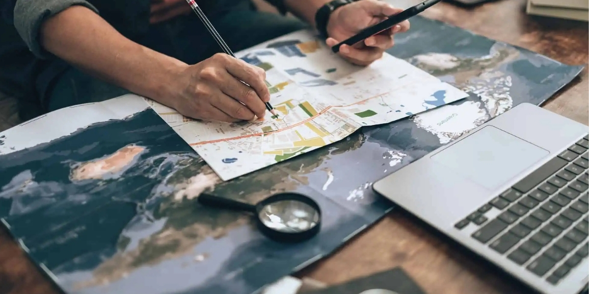 Traveller planning international journey with visa documents and map